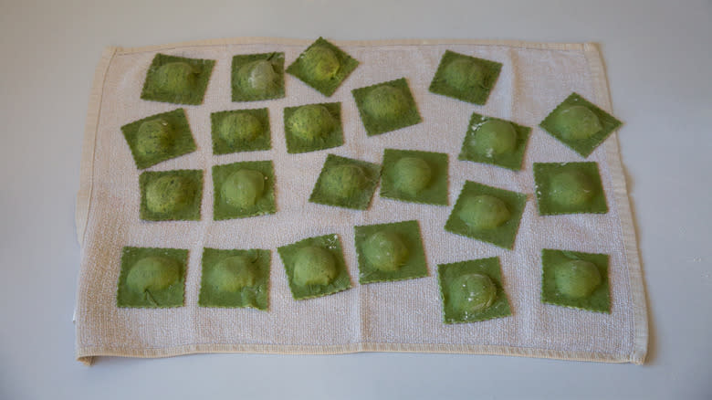 green ravioli drying on towel