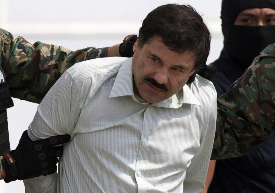 Joaquin "El Chapo" Guzman is escorted to a helicopter in handcuffs by Mexican navy marines at a navy hanger in Mexico City, Saturday, Feb. 22, 2014. A senior U.S. law enforcement official said Saturday, that Guzman, the head of Mexico's Sinaloa Cartel, was captured alive overnight in the beach resort town of Mazatlan. Guzman faces multiple federal drug trafficking indictments in the U.S. and is on the Drug Enforcement Administrationís most-wanted list. (AP Photo/Eduardo Verdugo)