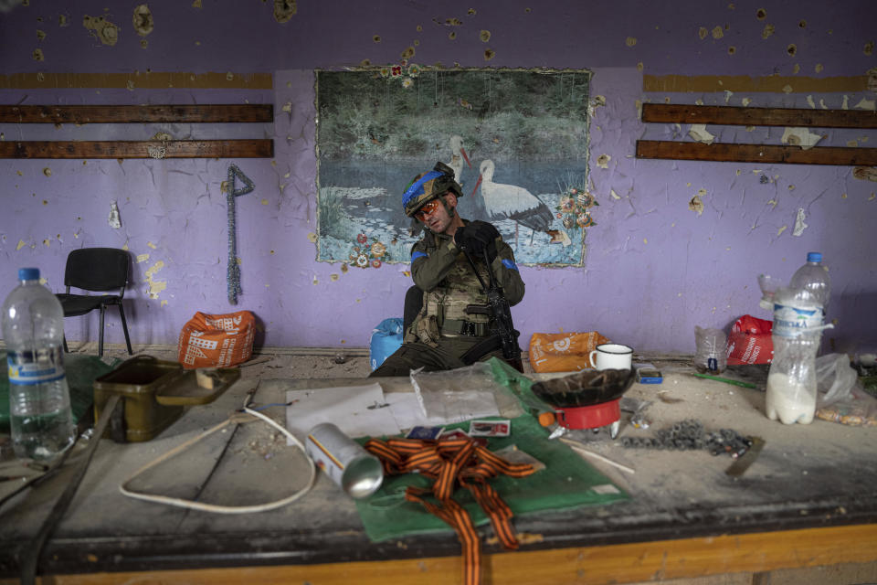 A Ukrainian commander, aka Lermontov, of the 68th Oleksa Dovbush hunting brigade, sits in a building in the recently retaken village of Blahodatne, Ukraine, Saturday, June 17, 2023. (AP Photo/Evgeniy Maloletka)