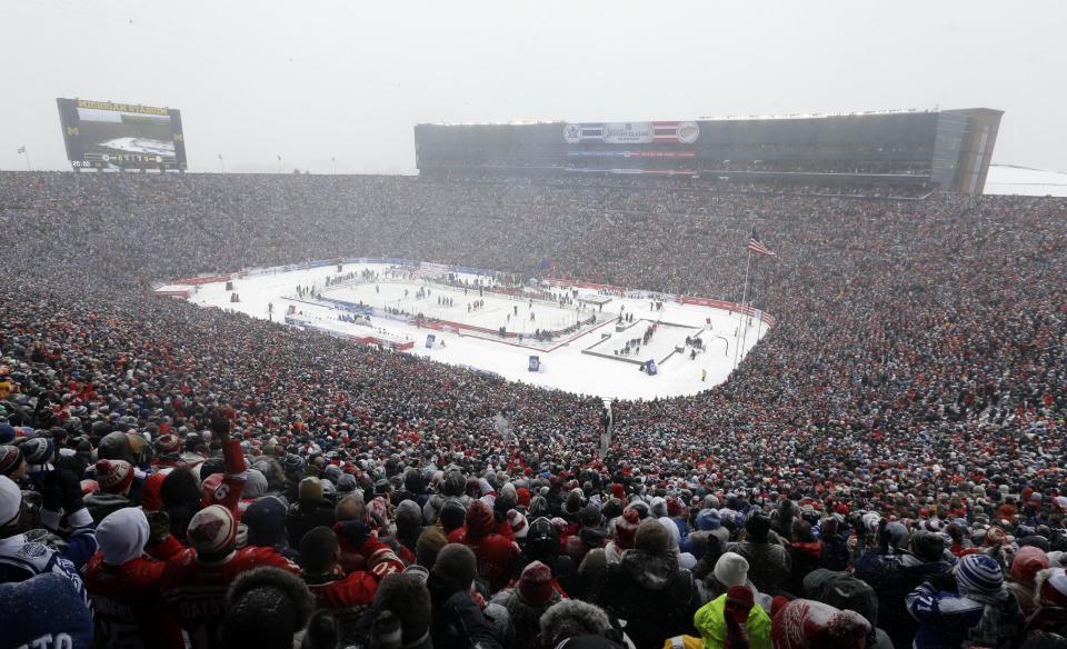 Hockey fans stand during the national anthems before the Winter Classic outdoor NHL hockey game between of the Toronto Maple Leafs and the Detroit Red Wings at Michigan Stadium in Ann Arbor, Mich., Wednesday, Jan. 1, 2014. (AP Photo/Carlos Osorio)