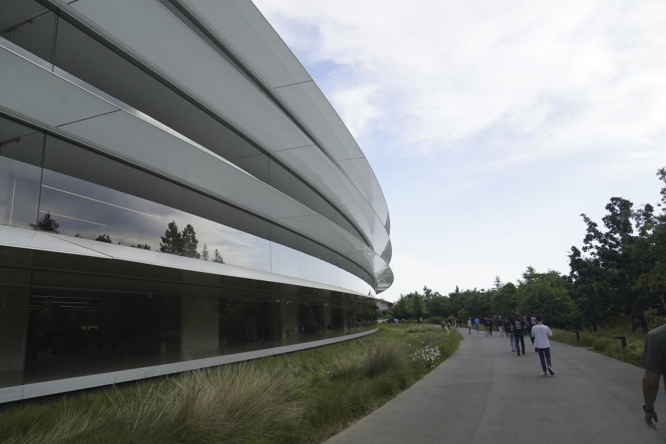 People walk along a paved path Monday, June 5, 2023, before an announcement on new products on the Apple campus in Cupertino, Calif. (AP Photo/Jeff Chiu)