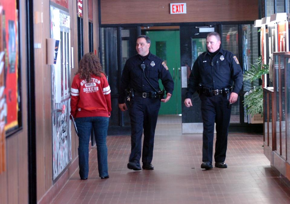 2009 file photo: School police supervisors Ted Hancock, left, and Daniel Vaughn patrol inside Brockton High School on Thursday morning, a day after a former student was shot after school outside the gymnasium.