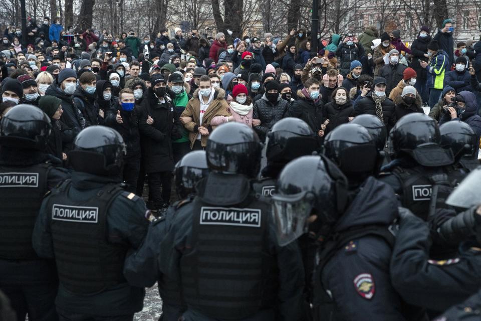 FILE - In this Jan. 23, 2021, file photo, police officers confront people protesting the jailing of opposition leader Alexei Navalny in Moscow, Russia. Rattled by nationwide demonstrations over Navalny, Russian authorities are moving rapidly to block any new ones – from piling legal pressure on his allies to launching a campaign to discredit the rallies. (AP Photo/Pavel Golovkin, File)