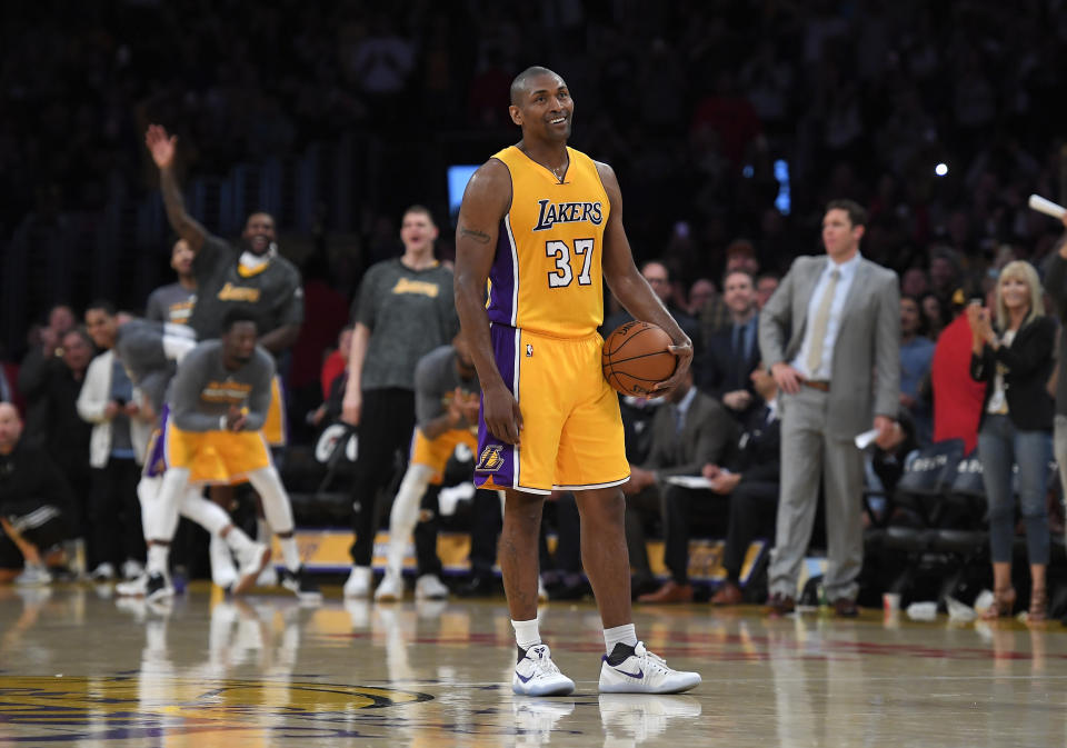 Metta World Peace stands on the court while teammates and fans cheer as the 24-second clock runs out near the end of the team’s last game of the 2016-17 NBA season. (AP)