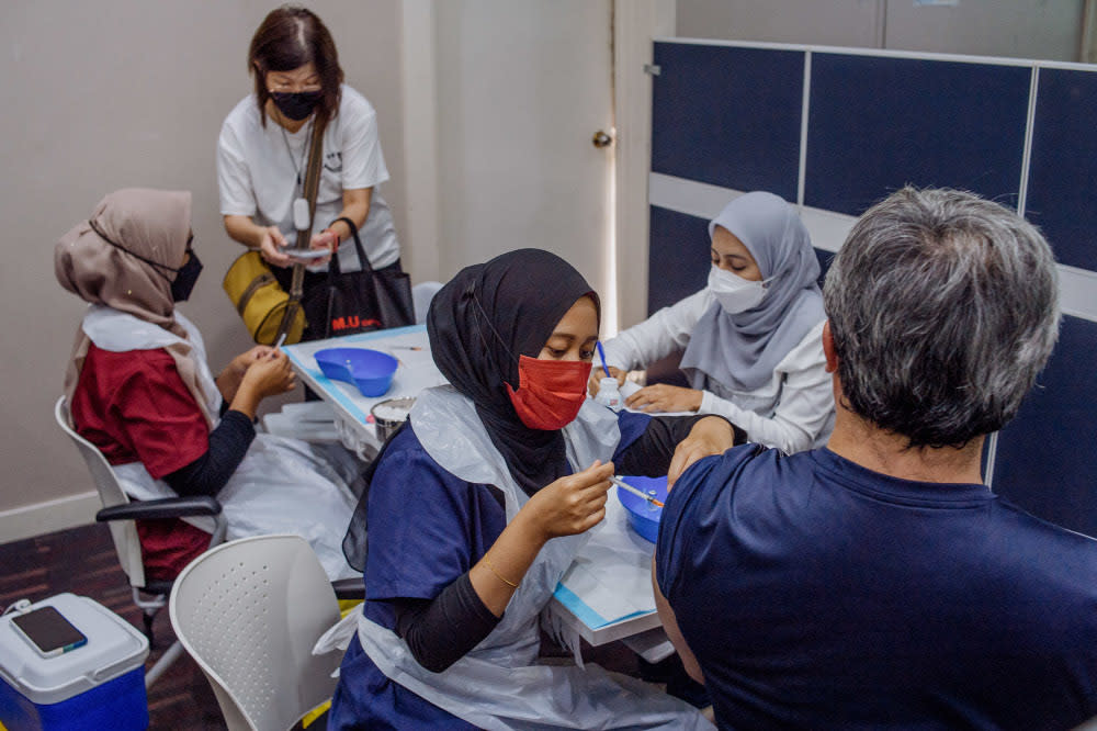 People receive their Covid-19 booster jabs at the UEM Learning Centre in Petaling Jaya, November 24, 2021. — Picture by Shafwan Zaidon