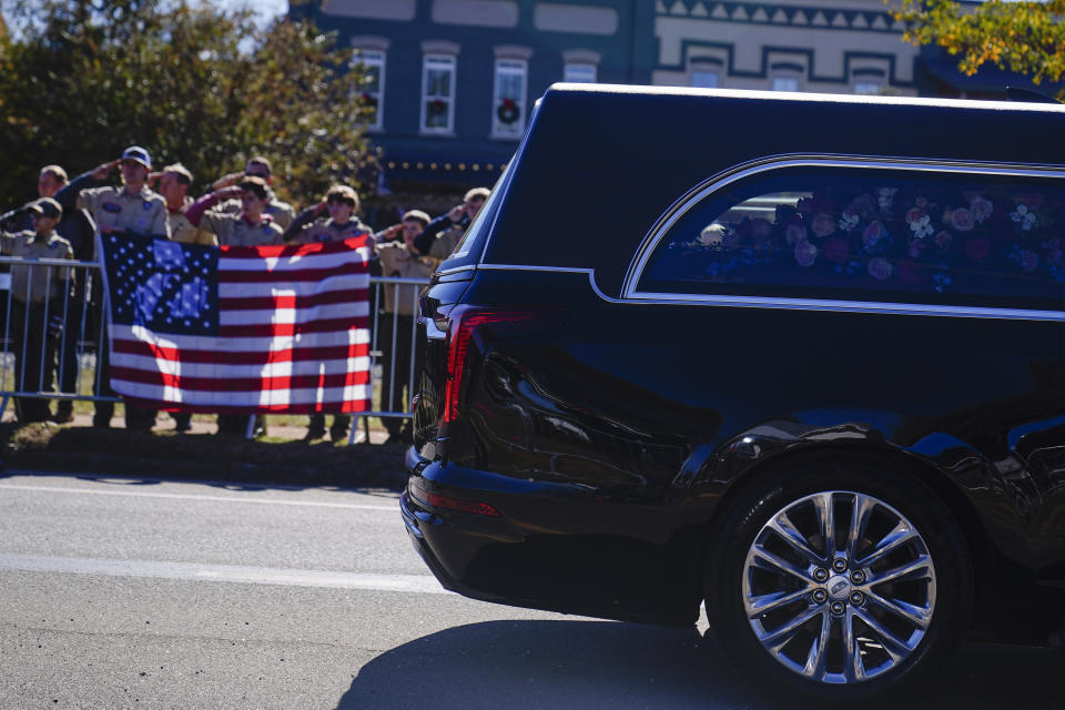 Boy scouts salute as the hearse moves during the funeral service for former first lady Rosalynn Carter, Wednesday, Nov. 29, 2023, in Plains, Ga. The former first lady died on Nov. 19. She was 96. (AP Photo/Brynn Anderson)