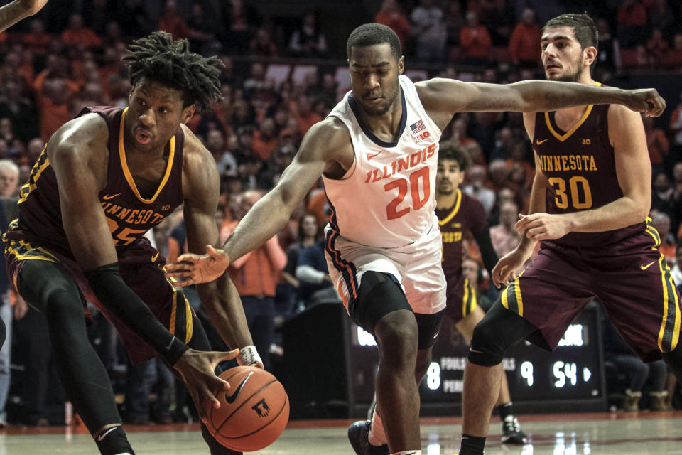 Illinois' DeMonte Williams (20) reaches in and knocks the ball loose from Minnesota's Daniel Oturu (25) in the second half of an NCAA college basketball game, Thursday, Jan. 30, 2020, in Champaign, Ill. (AP Photo/Holly Hart)
