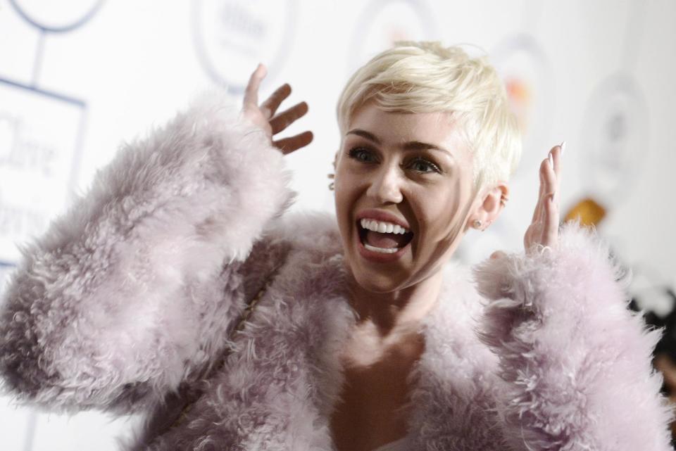 FILE - In this Jan. 25, 2014 file photo, Miley Cyrus arrives at the 56th annual GRAMMY awards - salute to industry icons with Clive Davis, in Beverly Hills, Calif. Cyrus is in the hospital and unable to perform her “Bangerz” concert at Kansas City’s Sprint Center as planned. A Cyrus spokeswoman says the 21-year-old entertainer canceled her performance Tuesday, April 15, 2014, after she was hospitalized for a severe allergic reaction to antibiotics. (Photo by Dan Steinberg/Invision/AP, file)