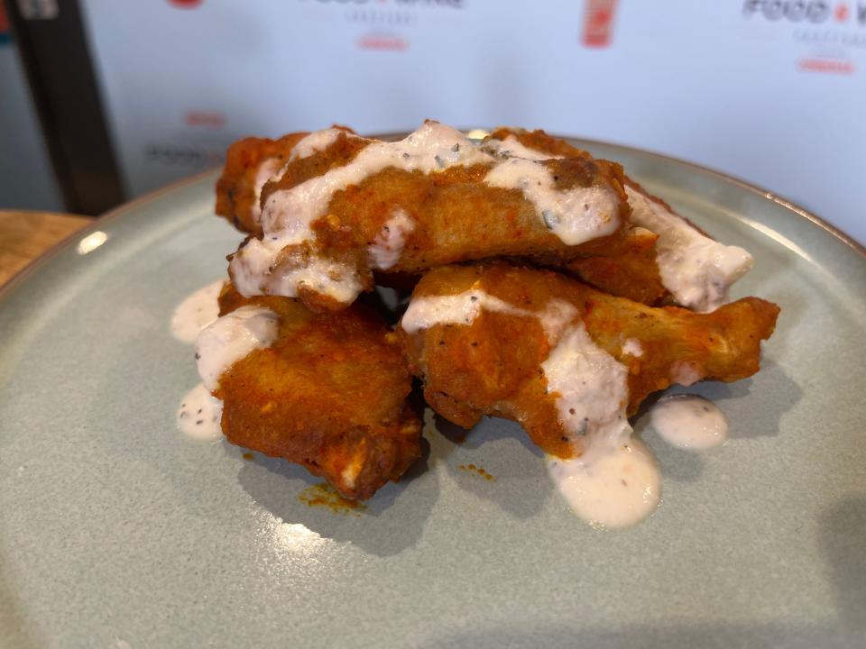 Unnecessarily Spicy, Yet Extremely Tasty Scotch bonnet pepper-curry wings with cool cucumber yogurt are available in the Odyssey pavilion's Brew-Wing Lab during the 2023 Epcot International Food and Wine Festival.