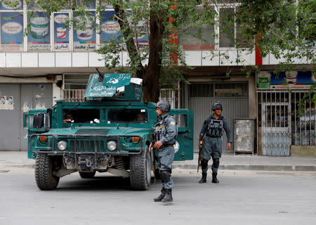 Afghan policemen keep watch a during gunmen attack in Kabul, Afghanistan May 8, 2019.REUTERS/Mohammad Ismail