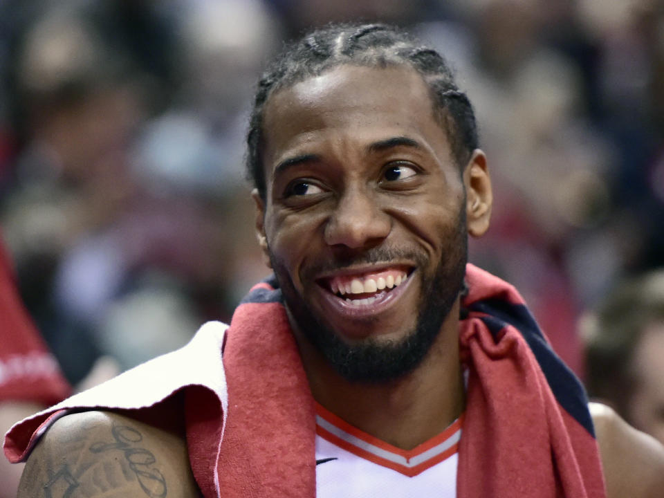 Toronto Raptors forward Kawhi Leonard (2) smiles from the bench during a late second half timeout in Game 5 of a first-round NBA basketball playoff series against the Orlando Magic, Tuesday, April 23, 2019 in Toronto. (Frank Gunn/Canadian Press via AP)