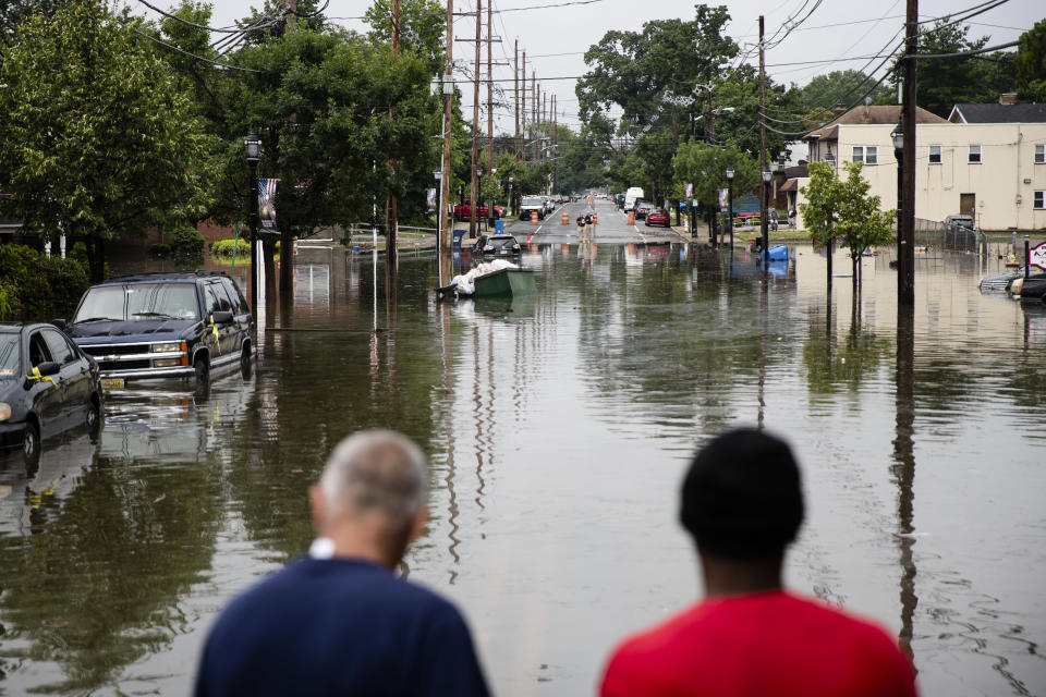 People inspect the floodwaters submerging Broadway in Westville, N.J. Thursday, June 20, 2019. Severe storms containing heavy rains and strong winds spurred flooding across southern New Jersey, disrupting travel and damaging some property. (Photo: Matt Rourke/AP)