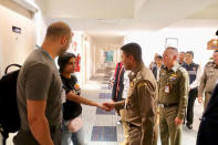 Saudi teen Rahaf Mohammed al-Qunun is greeted by Thai immigration authorities at a hotel inside Suvarnabhumi Airport in Bangkok, Thailand January 7, 2019. Thailand Immigration Police via REUTERS