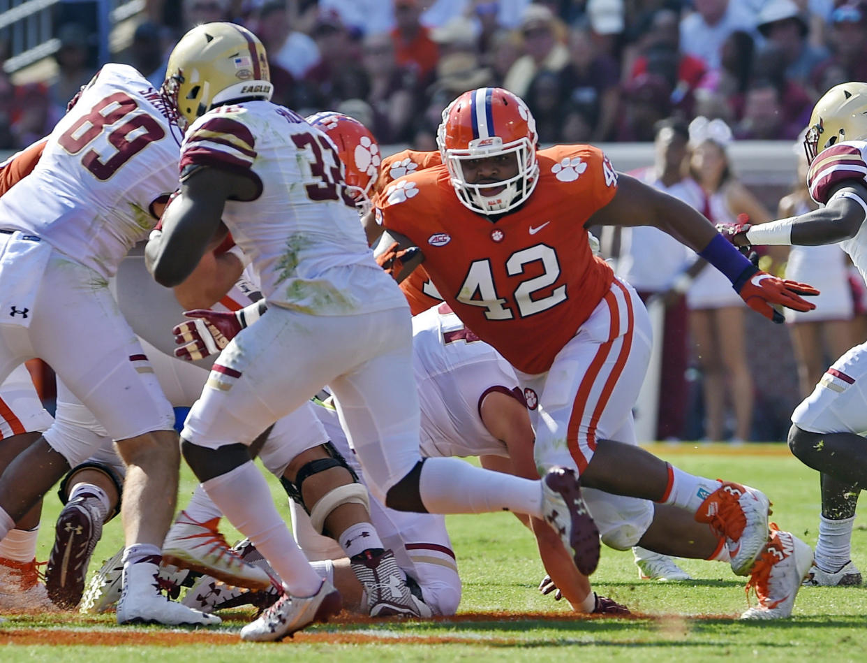 FILE – In this Sept. 23, 2017, file photo, Clemson’s Christian Wilkins (42) pursues a runner during the first half of an NCAA college football game against Boston College Clemson, S.C. The secret to Clemson retaining its stellar defensive line is not that mysterious, Tigers coach Dabo Swinney says: Expected first-rounders Christian Wilkins, Clelin Ferrell and Austin Bryant did not get the grades they anticipated from the NFL committee evaluating their draft chances. (AP Photo/Richard Shiro, File)