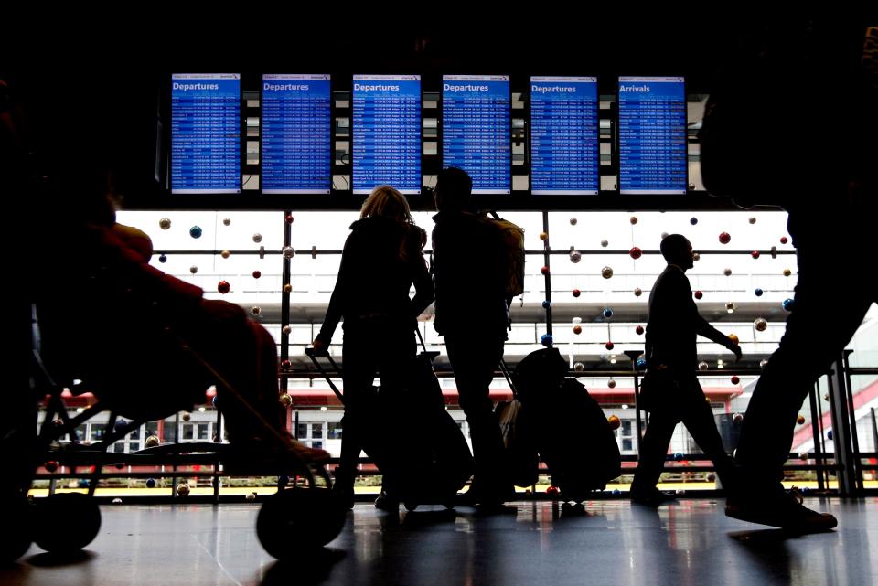 Travelers walk to their gates at O'Hare International