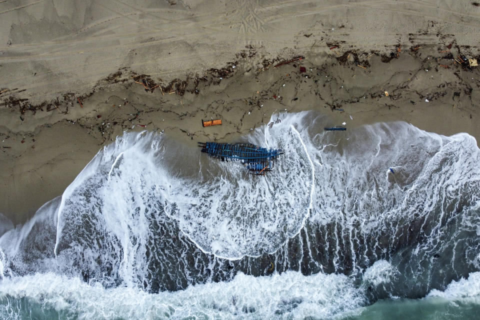 FILE - This Feb. 27, file photo, 2023 shows part of the debris of a wrecked migrant boat washed ashore after it capsized in the early morning of Sunday, Feb. 26, 2023, at a short distance from the shore in Steccato di Cutro, in the Italian southern tip, killing at least 94 people. Survivors and family members of the victims are converging in the area for a commemoration on Monday, Feb. 26, 2024, on the first anniversary of the disaster. (AP Photo/Luigi Navarra)