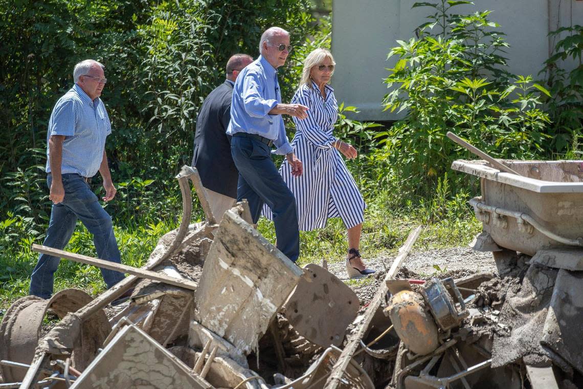 President Joe Biden and First Lady Dr. Jill Biden walk past items destroyed by flashing flooding last month in Eastern Kentucky while the Bidens visited Lost Creek, Ky., on Monday, Aug. 8, 2022.