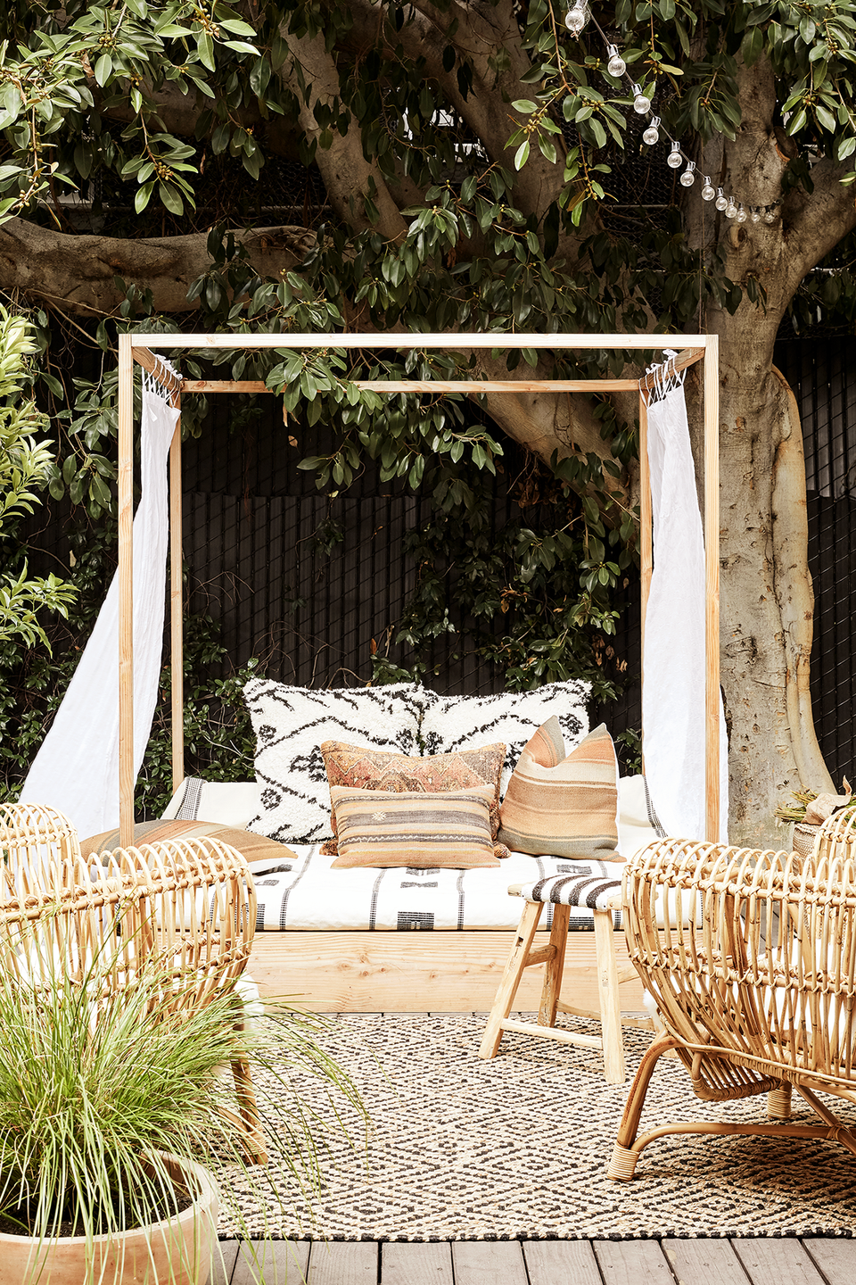 outdoor living space with canopy bed in the garden