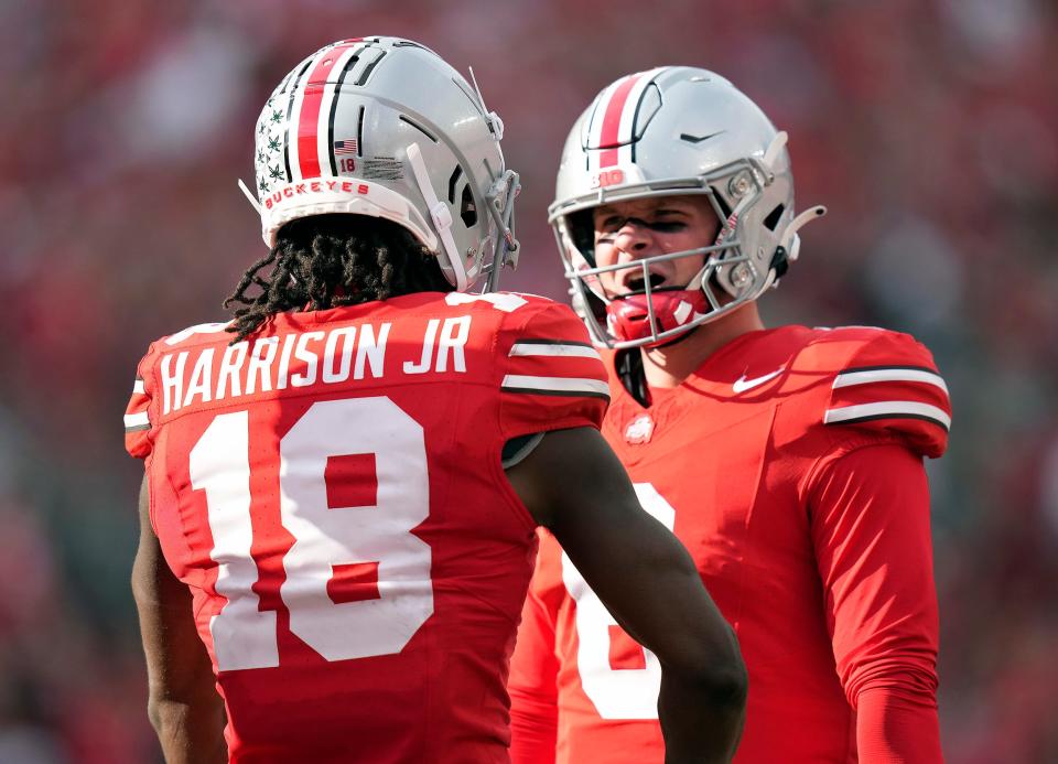 Sep 16, 2023; Columbus, Ohio, USA; Ohio State Buckeyes wide receiver Marvin Harrison Jr. (18) celebrates his touchdown catch with Ohio State Buckeyes quarterback Kyle McCord (6) against Western Kentucky Hilltoppers during the second quarter of their game at Ohio Stadium.