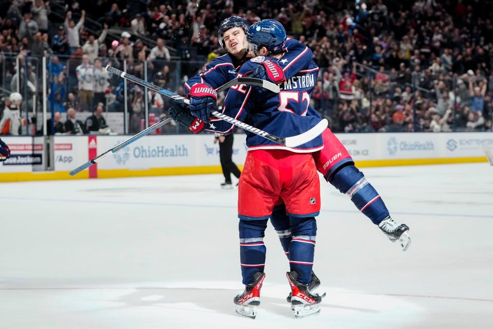 Oct 24, 2023; Columbus, Ohio, USA; Columbus Blue Jackets center Cole Sillinger (4) celebrates a goal by Columbus Blue Jackets right wing Emil Bemstrom (52) during the first period of the NHL game against the Anaheim Ducks at Nationwide Arena.