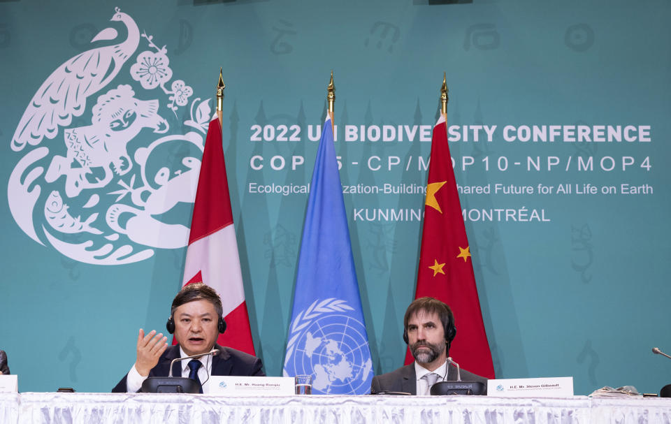 Huang Runqiu, Minister of Ecology and Environment of China and president of the COP15, responds to a question as Canadian Environment Minister Steven Guilbeault looks on during the closing news conference at the COP15 U.N. conference on biodiversity in Montreal, on Tuesday, Dec. 20, 2022. After a historic biodiversity agreement was reached, countries now face pressure to deliver on the promises. The most significant part of the global biodiversity framework is a commitment to protect 30% of land and water considered important for biodiversity by 2030. (Paul Chiasson/The Canadian Press via AP)