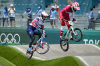 Bethany Shriever of Britain, left, and Zoe Claessens of Switzerland, right, compete in the women's BMX Racing quarterfinals at the 2020 Summer Olympics, Thursday, July 29, 2021, in Tokyo, Japan. (AP Photo/Ben Curtis)