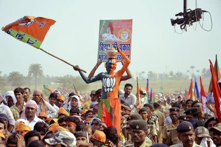 A supporter of India's ruling Bharatiya Janata Party (BJP) waves the party flag during an election campaign rally addressed by India's Prime Minister Narendra Modi (not pictured) in Banka, in the eastern state of Bihar October 2, 2015. REUTERS/Stringer