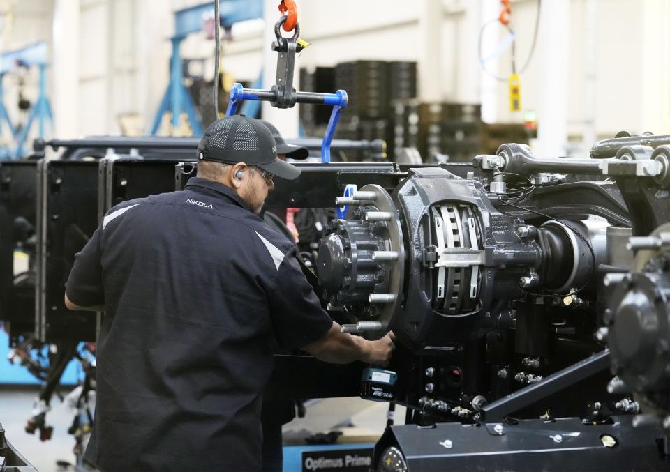 A production line worker builds the zero-emission Nikola Tre BEV truck at the Nikola truck manufacturing facility in Coolidge on April 27, 2022.