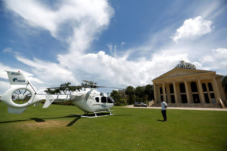 A man stands near a Union Development Group helicopter in front of an old casino at Dara Sakor hotel at Botum Sakor in Koh Kong province, Cambodia, May 6, 2018. REUTERS/Samrang Pring