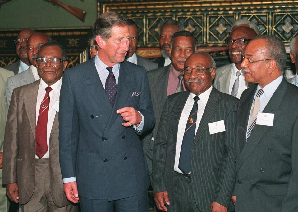 LONDON, UNITED KINGDOM - JUNE 25:  Britain's Prince Charles talks with some of the original settlers from the Caribbean, 25 June, when he hosted, at James Palace, a reception to mark the 50th anniversary of the arrival in the UK of the SS Empire Windrush. The Windrush brought the first Caribbean settlers to Britain. The Prince met some of those who made the pioneering voyage in answer to the call for labour after the Second World War.  (Photo credit should read JOHNNY EGGITT/AFP via Getty Images)