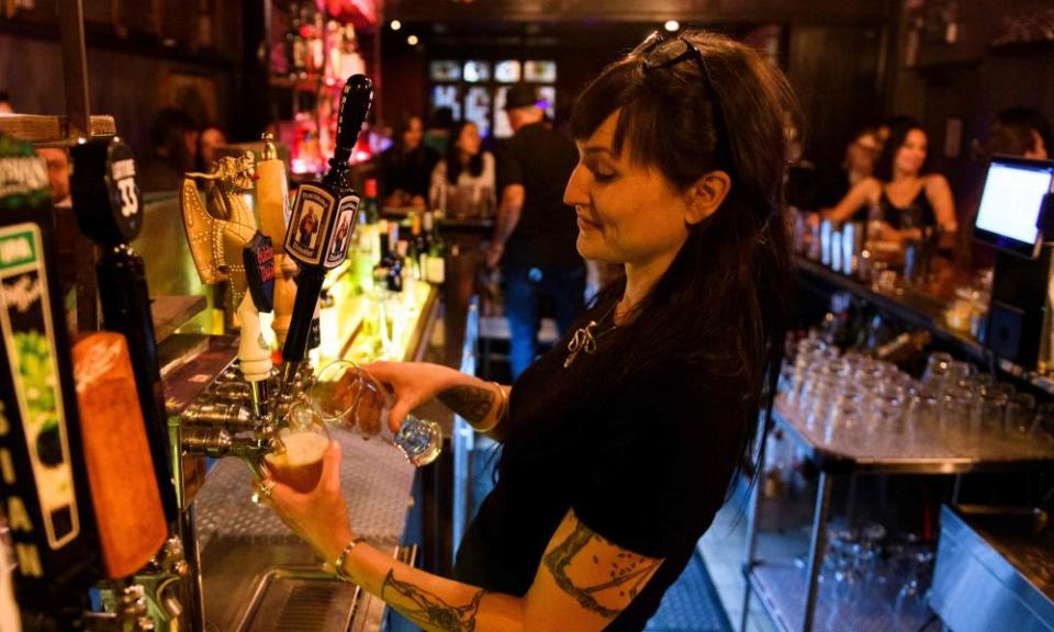 A bartender pours beers at the Risky Business in Los Angeles on 21 May.