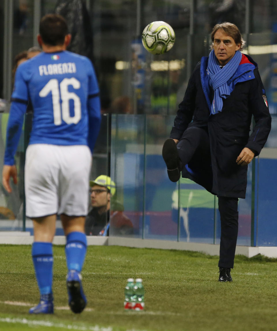 Italy coach Roberto Mancini, right, kicks the ball during the UEFA Nations League soccer match between Italy and Portugal at the San Siro Stadium, in Milan, Saturday, Nov. 17, 2018. (AP Photo/Antonio Calanni)