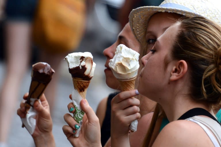 Tourists eat ice creams in central Rome's Barcaccia fountain while elsewhere in the Italian capital a zoo was offering gelato to orangutans