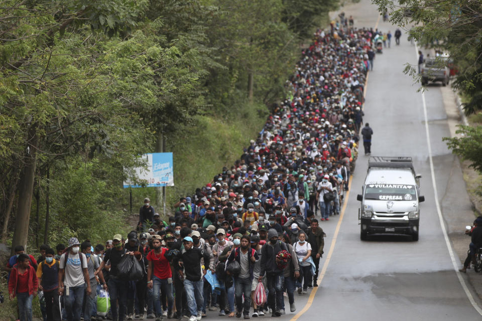 Honduran migrants hoping to reach the U.S. border walk alongside a highway in Chiquimula, Guatemala, Saturday, Jan. 16, 2021. Guatemalan authorities estimated that as many as 9,000 Honduran migrants have crossed into Guatemala as part of an effort to form a new caravan to reach the U.S. border. (AP Photo/Sandra Sebastian)