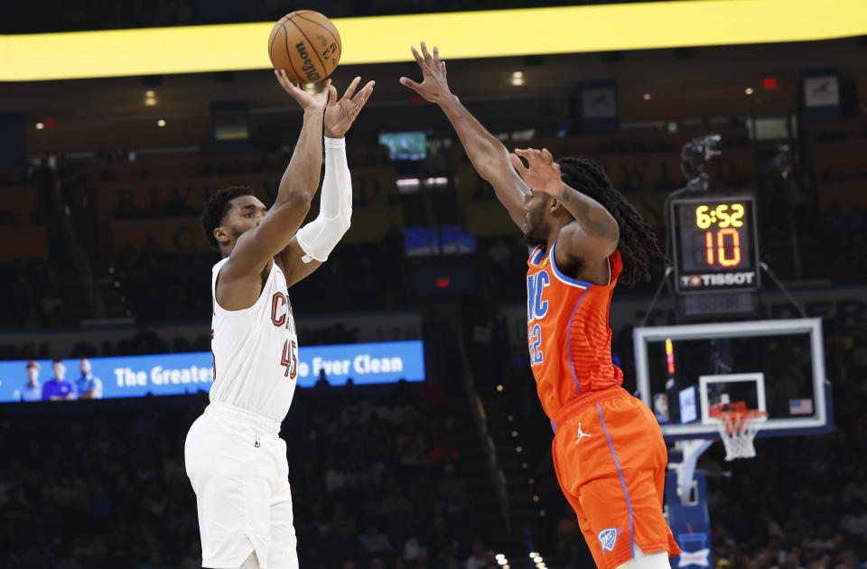 Nov 8, 2023; Oklahoma City, Oklahoma, USA; Cleveland Cavaliers guard Donovan Mitchell (45) shoots as Oklahoma City Thunder guard Cason Wallace (22) defends during the second quarter at Paycom Center. Mandatory Credit: Alonzo Adams-USA TODAY Sports