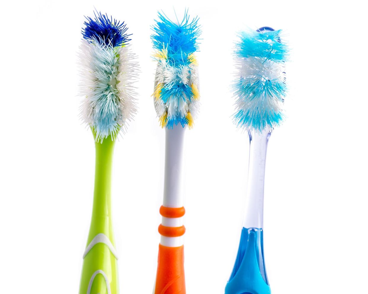 old used colorful toothbrushes