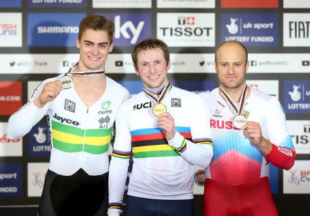 Cycling - UCI World Track Cycling Championships - London, Britain - 5/3/2016 - Jason Kenny of Britain (C), winner of the men's sprint final, poses on the podium with second-placed Matthew Glaetzer of Australia (L) and third-placed Denis Dmitriev of Russia.REUTERS/Matthew Childs