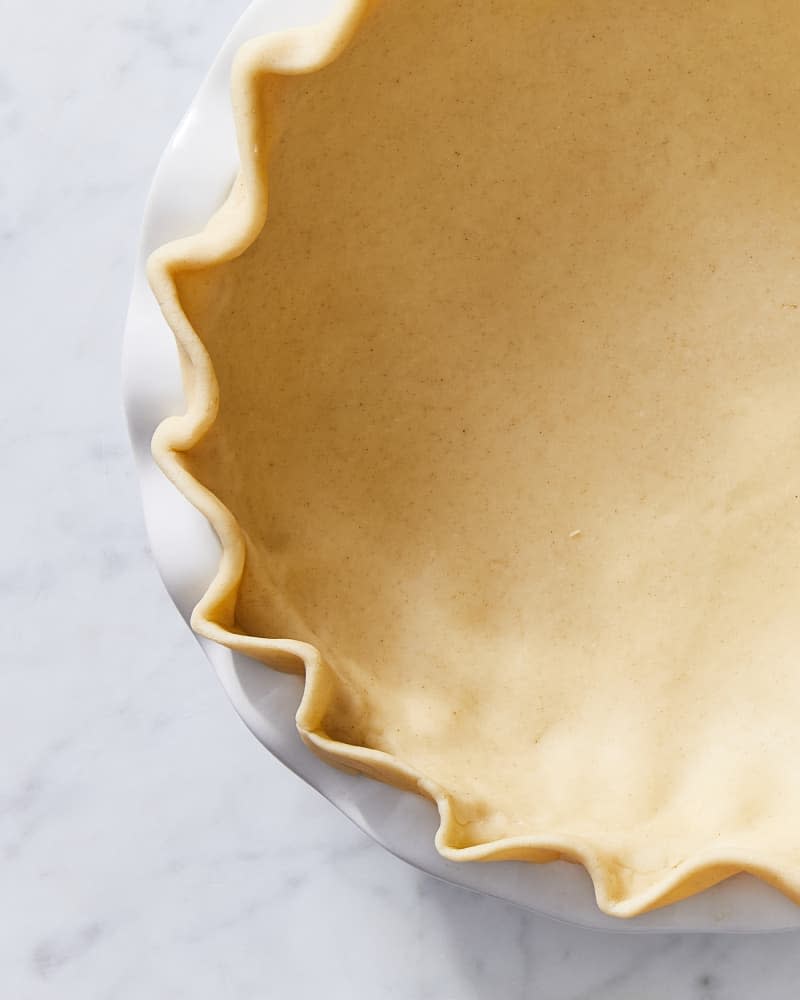Overhead macro photo of a pie crust that's been crimped in the wave style
