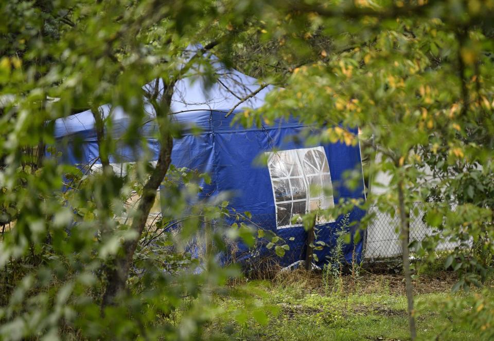 A police tent is seen during the investigation at the allotment garden plot. Source: Ap