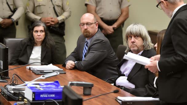 PHOTO: Louise Anna Turpin, far left, with attorney Jeff Moore, second from left, and her husband, David Allen Turpin, listen to attorney David Macher, as they appear in court for their arraignment in Riverside, Calif., Jan. 18, 2018. (Frederic J. Brown/AP, FILE)