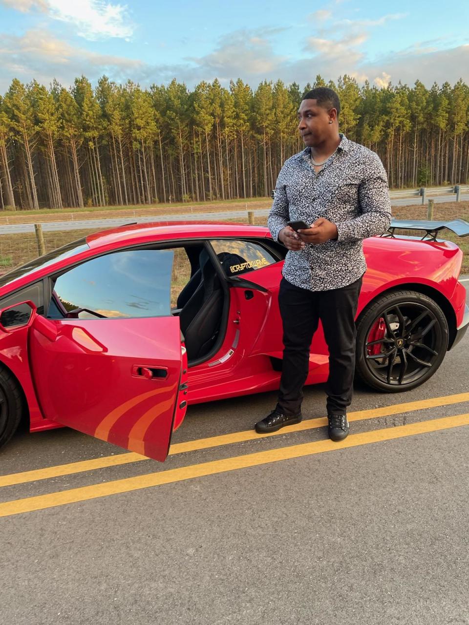 Kwame Jones with his red Lamborghini.