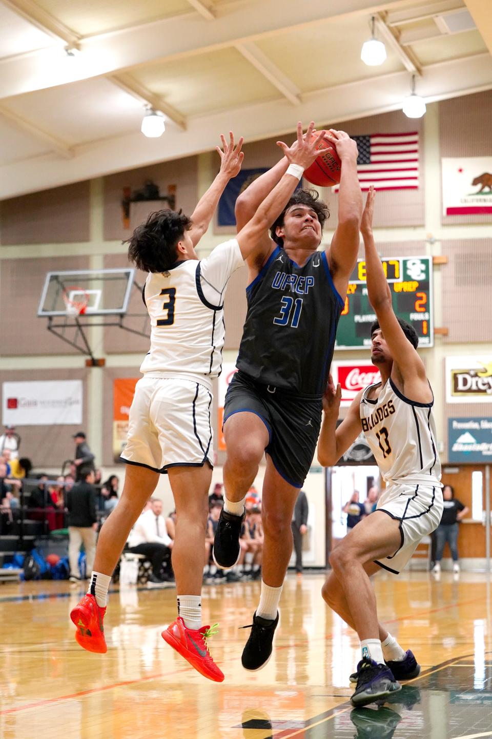 U-Prep’s Devin Huegel (31) goes up to shoot 2 points against Gridley’s Luis Murillo (3) and Shmaas Khan (13) in the first quarter of the Championship game on Saturday at Shasta College.