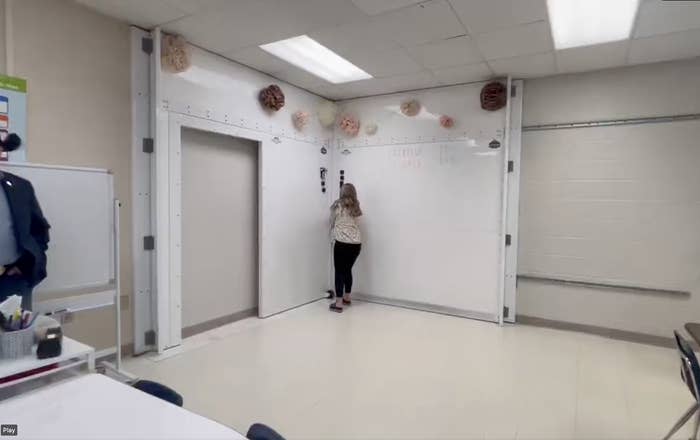 A person in the corner of a classroom activating the shield