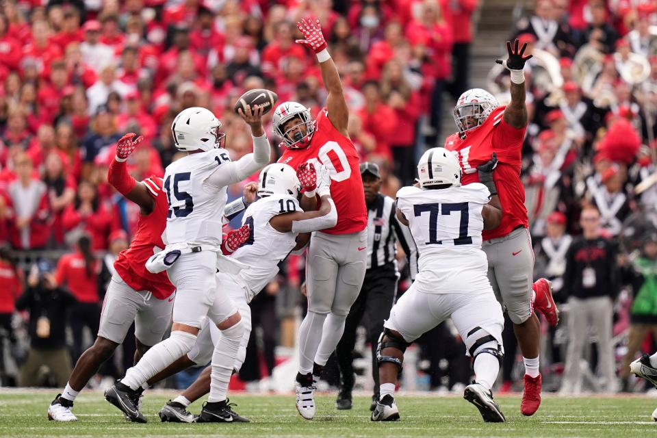 Ohio State linebacker Cody Simon (30) and defensive tackle Michael Hall Jr. (51) try to disrupt the pass of Penn State quarterback Drew Allar on Saturday.