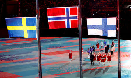 FILE PHOTO: Pyeongchang 2018 Winter Olympics - Closing ceremony - Pyeongchang Olympic Stadium - Pyeongchang, South Korea - February 25, 2018 - Gold medallist Marit Bjoergen of Norway, silver medallist Krista Parmakoski of Finland and bronze medallist Stina Nilsson of Sweden during the closing ceremony. REUTERS/Issei Kato/File Photo