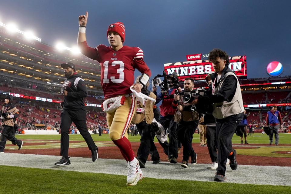 San Francisco quarterback Brock Purdy celebrates as he runs off the field after defeating the Seattle Seahawks in a playoff game this season.