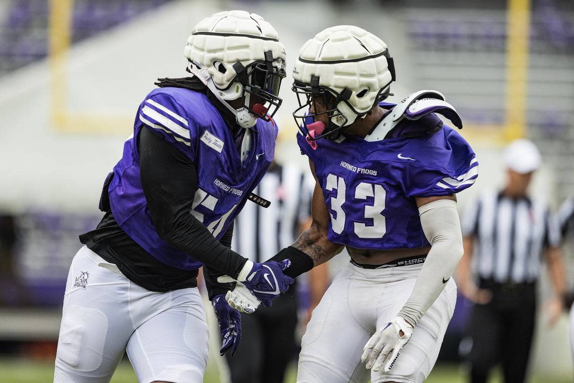 TCU defensive lineman Nana Osafo-Mensah (54) and linebacker Max Carroll (33) celebrate after making a defensive play in a TCU football Spring Scrimmage at Amon G. Carter Stadium in Fort Worth on Saturday, April 27, 2024.