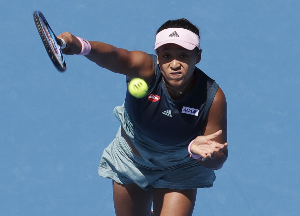 Japan's Naomi Osaka makes a forehand return to Ukraine's Elina Svitolina during their quarterfinal match at the Australian Open tennis championships in Melbourne, Australia, Wednesday, Jan. 23, 2019. (AP Photo/Aaron Favila)