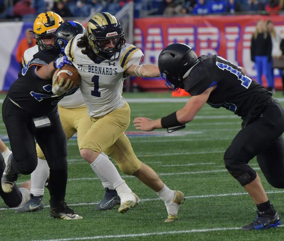 St. Bernard’s Antonio Mancini runs between West Boylston’s Aidan Hamilton and Luke Foley Friday, December 2, 2022.