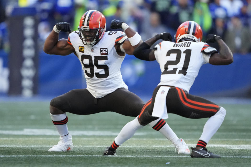Cleveland Browns defensive end Myles Garrett (95) and cornerback Denzel Ward (21) celebrate a sack by Garrett of Seattle Seahawks quarterback Geno Smith in the second half of an NFL football game, Sunday, Oct. 29, 2023, in Seattle. (AP Photo/Lindsey Wasson)